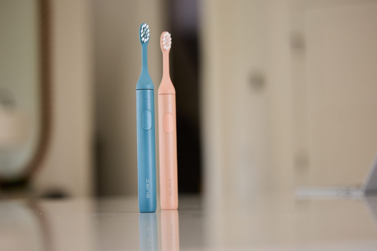 Suri Sonic Electric Toothbrushes on a bathroom counter